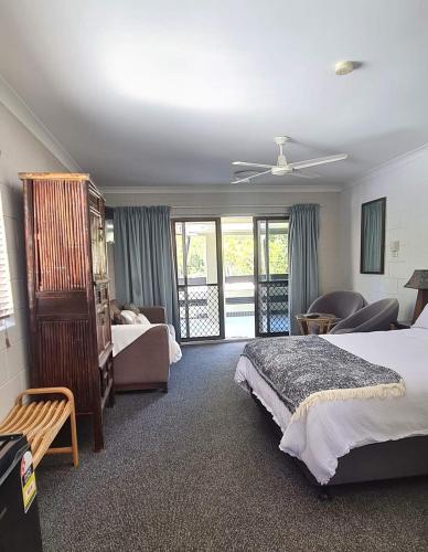a hotel room with two beds and a balcony at Bramston beach resort in Bramston Beach