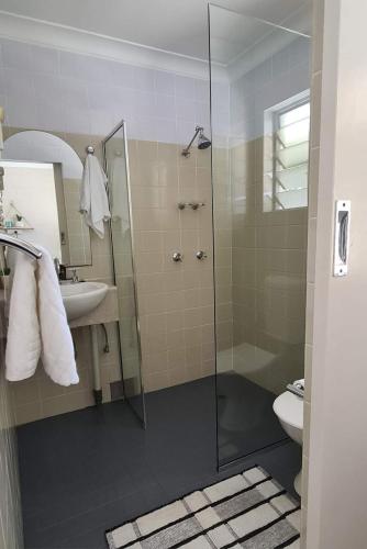 a bathroom with a shower and a toilet and a sink at Bramston beach resort in Bramston Beach
