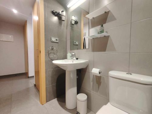 a white bathroom with a sink and a toilet at Mazi Apartments Nest in Mataró