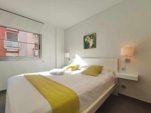 a bedroom with a large white bed with a window at Mazi Apartments Nest in Mataró