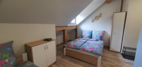 a small room with a bed and a staircase at Zajazd Stronie in Stronie Śląskie