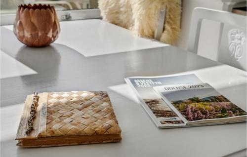 a table with a book and a magazine on it at 2 Bedroom Cozy Home In Ebberup in Ebberup