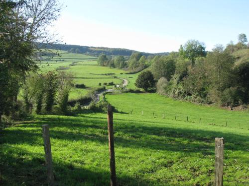 a fence in the middle of a green field at Hotel La Heid des Pairs in Spa