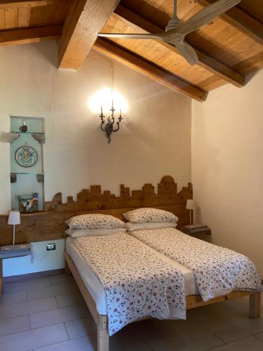 a bedroom with a bed and a chandelier at Chiesa Ignano 1778 in Marzabotto