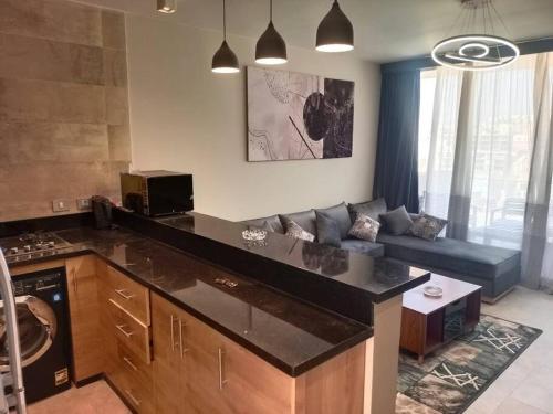 a kitchen and living room with a couch in a room at Lagoon View 2 Bedroom IL Monte Galala Ain Sokhna C2-CH28-2-1 in Ain Sokhna