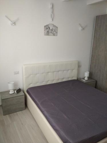 a bedroom with a bed and two night stands at Casa vacanze Venere in Balestrate