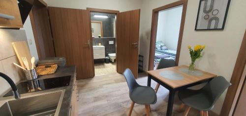 a kitchen with a table and a dining room at Zajazd Stronie in Stronie Śląskie