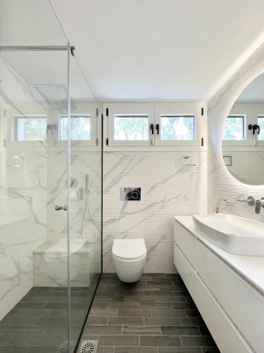a bathroom with a toilet and a sink and a shower at Sani Villa Christy in Sani Beach