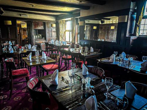 a dining room with tables and chairs and tablesktop at Rising Sun Hotel in Lynmouth