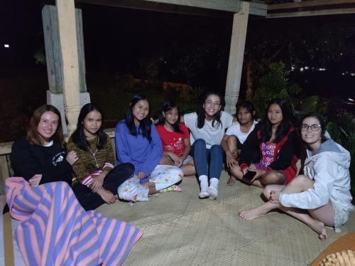 a group of women sitting on the ground at night at NUANSA HOMESTAY Authentic&Hospitality in Rantepao