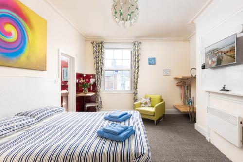 a bedroom with a king sized bed and a chair at Royal Discovery in Whitby
