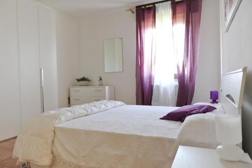 En eller flere senge i et værelse på Aleanna Appartamenti