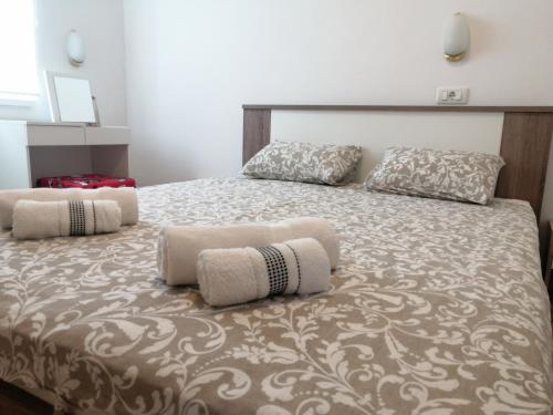 a bedroom with a bed with two pillows on it at Apartment Layla - Intermezzo with sea view in center of Rabac in Rabac