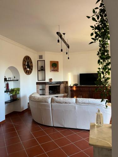 a living room with a white couch and a fireplace at B&b filì Al casale 1121 in Rome