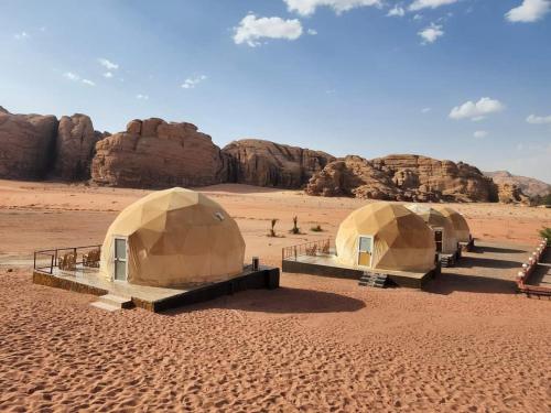a group of three tents in the desert at orbit camp 2 in Wadi Rum