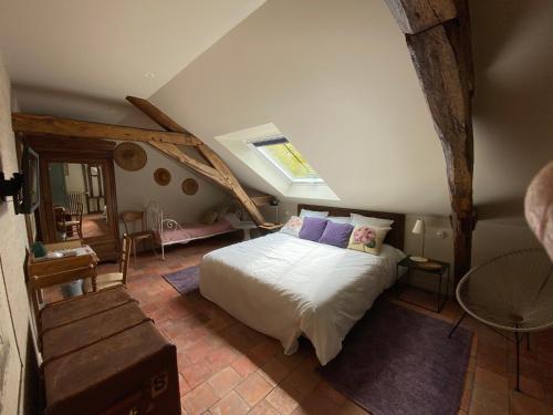 a bedroom with a bed in a attic at La Gironnerie in Loché-sur-Indrois