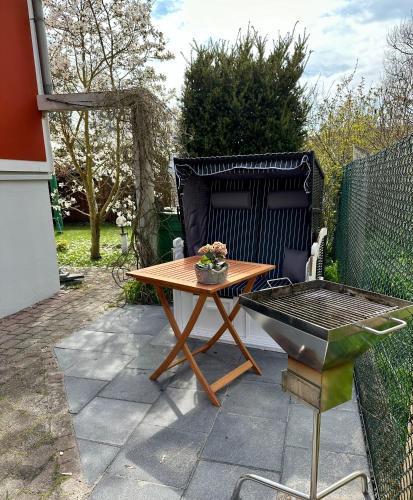 a patio with a table and a barbecue grill at Ferienwohnung Damerow in Zinnowitz