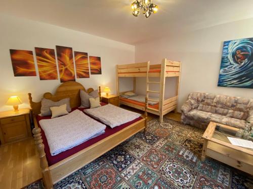 a bedroom with a bunk bed and a couch at Felsenmühle Neuleiningen in Neuleiningen