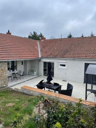 a house with a patio with a statue in the yard at U Vlcaku in Vřesovice