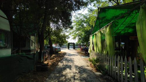 a street with a white fence and a building at Camping Mitikas and Bungalows in Plaka Litochorou