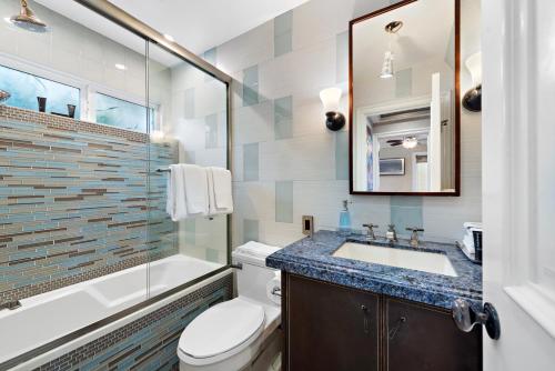 a bathroom with a toilet and a sink and a shower at Villa Leone at the Retreat in Laguna Beach in Laguna Beach