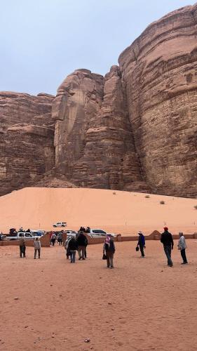 a group of people walking in the desert at orbit camp 2 in Wadi Rum