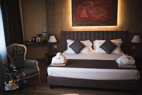a hotel room with a bed and a chair at Lake Hotel La Pieve in Pisogne