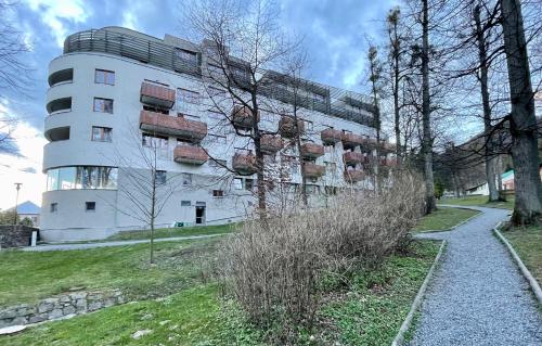 a white building with plants in front of it at Apartmán v srdci Beskyd - Čeladné in Kunčice pod Ondřejníkem