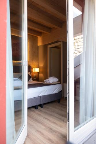 a view of a bedroom with a bed through a window at Lake Hotel La Pieve in Pisogne