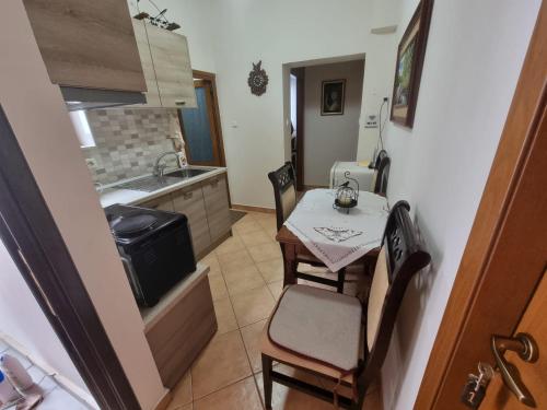 a small kitchen with a small table and chairs at Romeo's Guest House in Berat