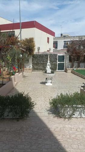 a courtyard with a fountain in front of a building at DOLCE VITA in Bitonto