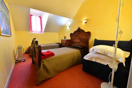 a bedroom with a bed and a couch in it at Au Pied du Chateau in Lourdes