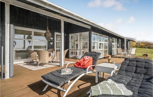 a screened in porch with chairs and a table at 2 Bedroom Cozy Home In Ebberup in Ebberup