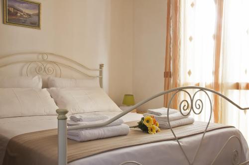 a white bed with towels and a stuffed animal on it at Appartamento Lido Vistamare in Gallipoli
