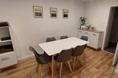 comedor con mesa blanca y sillas en Przytulne mieszkanie w Olkuszu/ Cosy apartment in Olkusz, en Olkusz