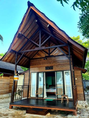 a small house with a gambrel roof at Beach House Penida in Nusa Penida