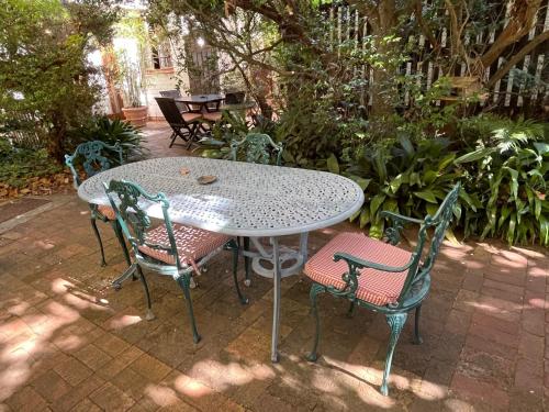 a table and chairs sitting on a patio at Constantia Guest House in Cape Town