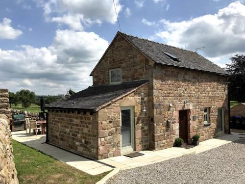 a small brick building with a door on the side at Chic 2 Bed Near Alton Towers, Polar Bears, Peak District in Leek