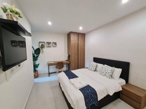 Schlafzimmer mit einem Bett und einem Flachbild-TV in der Unterkunft Lovely Kozi Square Studio 1 Bedroom with Pool LV7E in Kuching