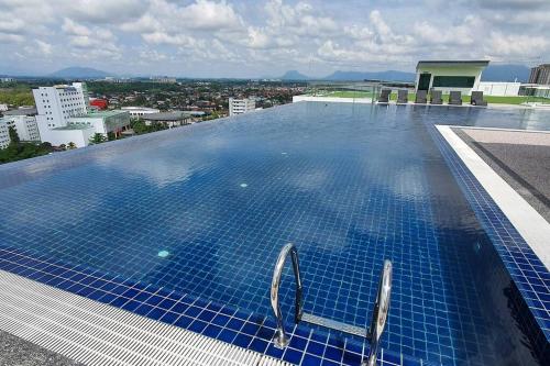 a large swimming pool on top of a building at Lovely Kozi Square Studio 1 Bedroom with Pool LV7E in Kuching