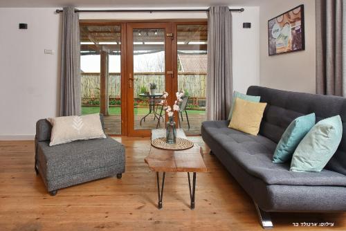 a living room with two couches and a table at Suites Tuia in Had Nes