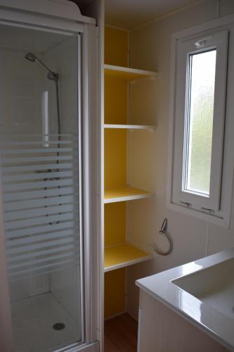 une salle de bain avec une douche et un lavabo et une fenêtre dans l'établissement Camping du Creulet, à Crouay
