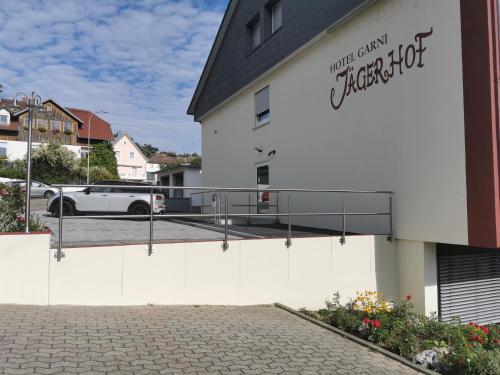 a white building with a sign on the side of it at Hotel Garni Jägerhof in Sigmaringen