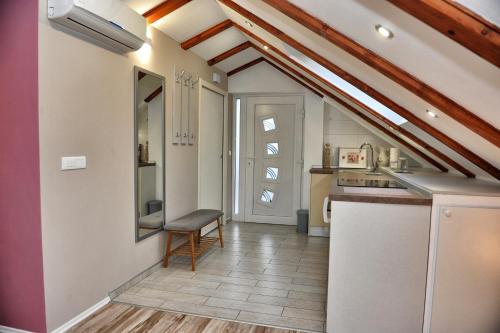 a kitchen with a table and a bench in a room at Apartman Harmony in Kastav