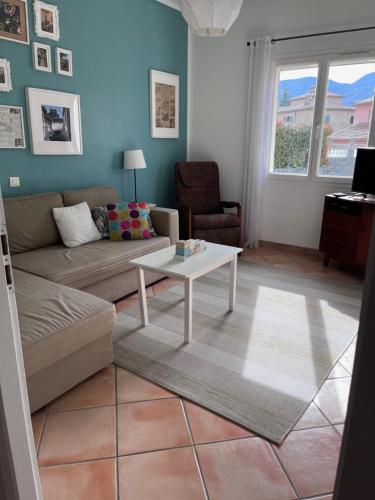 a living room with a couch and a coffee table at Villa les Rosiers in Tallard