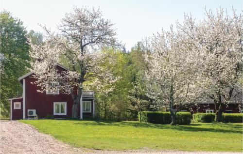a red house with trees and a gravel road at Amazing Home In Vetlanda With Wifi in Vetlanda
