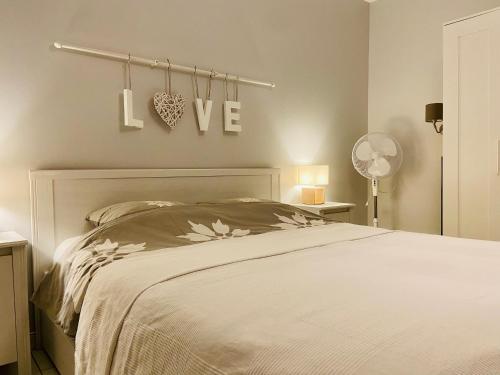 a bedroom with a bed and a sign that says i love at Sweet Home - 55m2 appt, garden, swimming pool, parking in Toulouse
