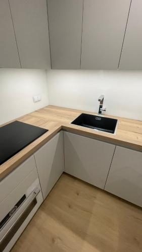 a kitchen with a sink and a counter at APARTAMENT 4 bed 2 room WARSAW in Warsaw
