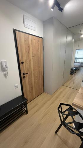 a room with a door and a bench and a mirror at APARTAMENT 4 bed 2 room WARSAW in Warsaw