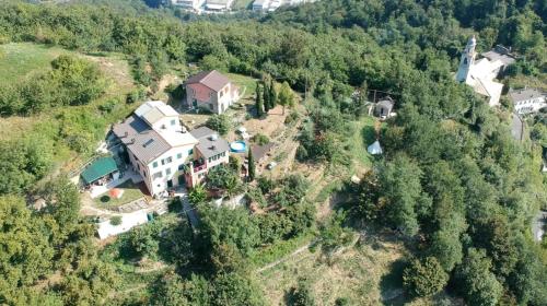 an aerial view of a large house in the forest at @gatetothewild in Coreglia Ligure